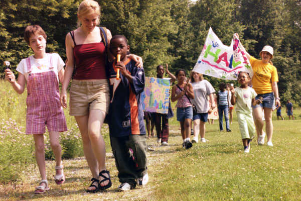 Image of campers holding hands and walking