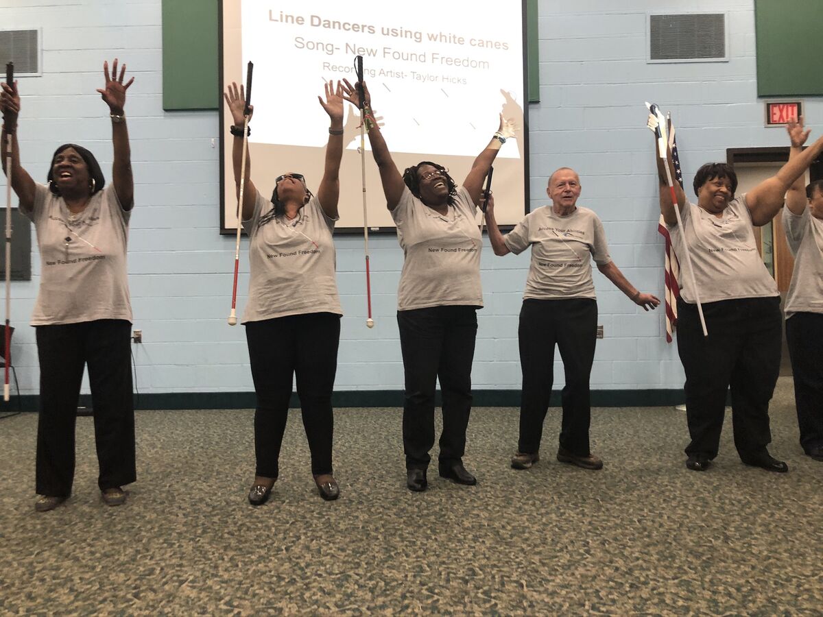image of clients dancing with their white canes