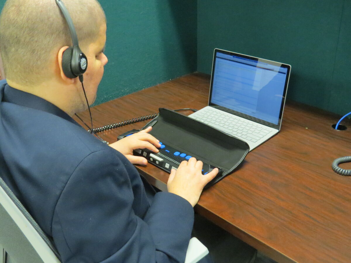 Image of a person typing on a computer