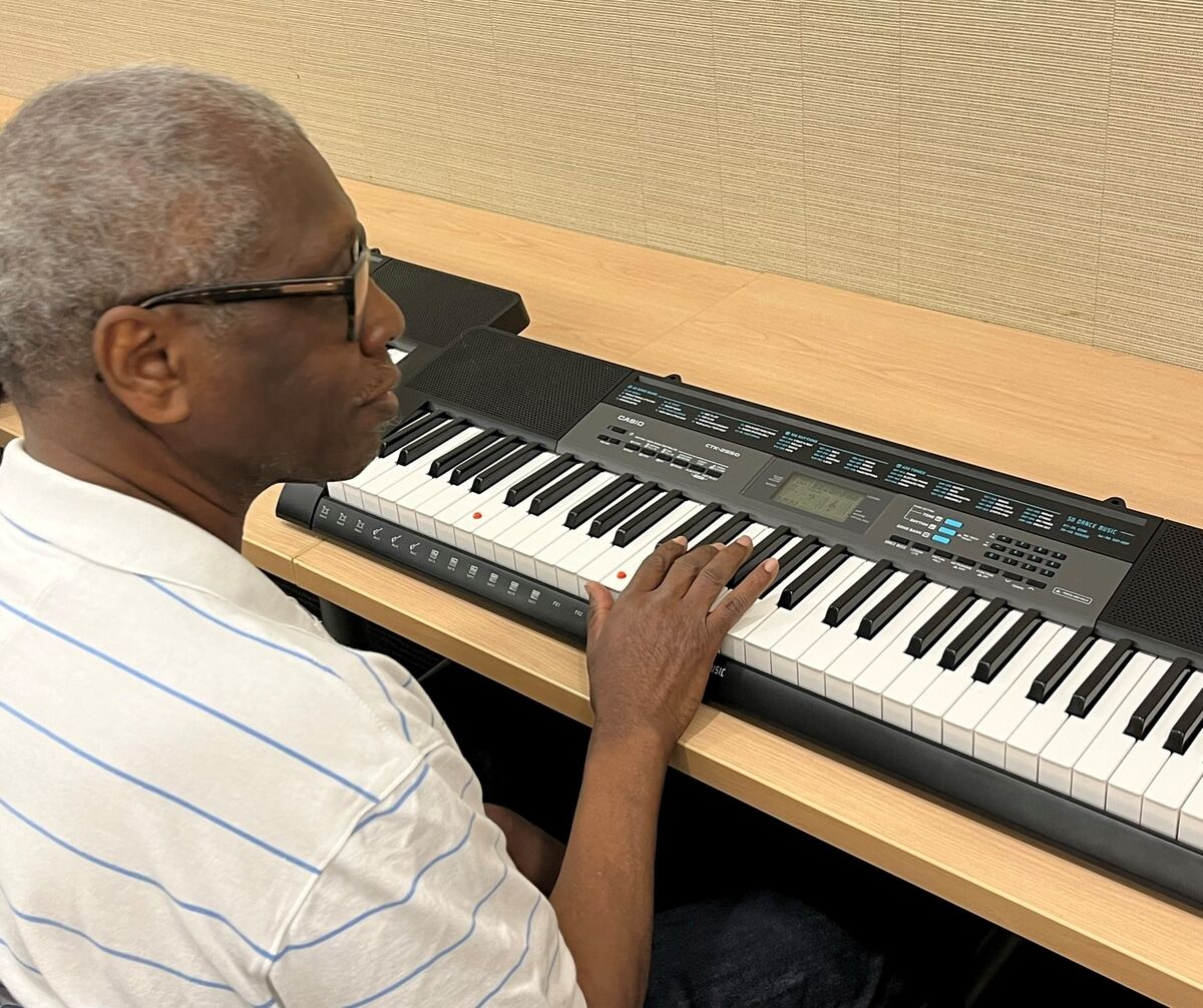 John practices a chord he learned in piano class