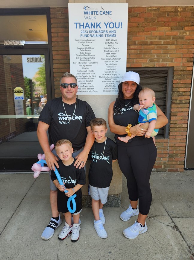 All five members of the Campbell family pose for a picture together while wearing matching White Cane Walk t-shirts. 