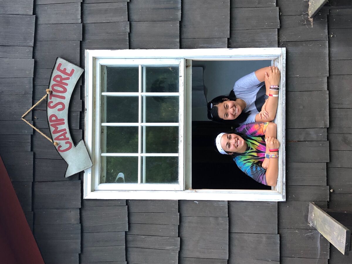 Image of two camp counselors smiling for the camera