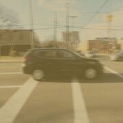 An example of what vision can look like with cataracts. The image of the car is discolored and blurry.