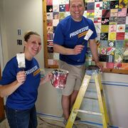 Two volunteers touching up paint.