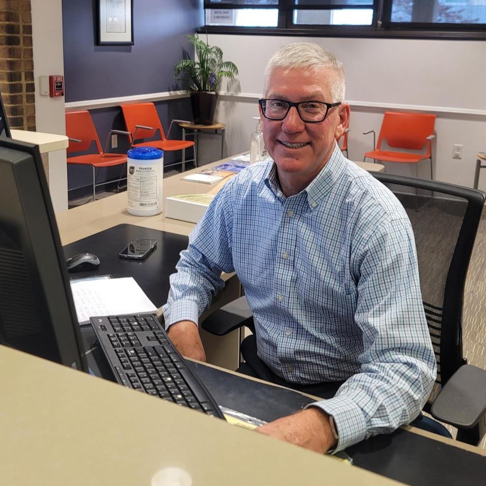 Dave smiles for the camera as he sits behind the front desk at CSC