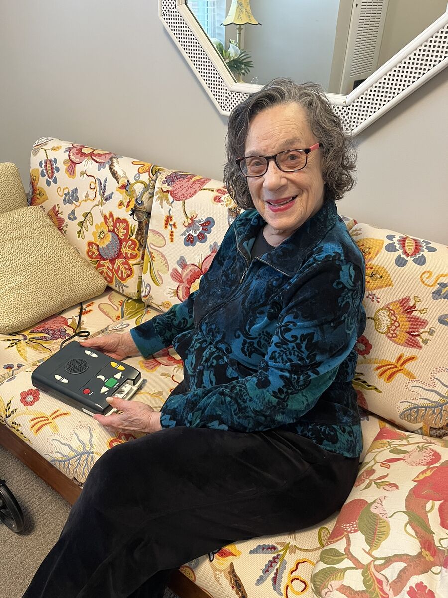 Ilene smiles for a photo as she shows off her book reading device from the Ohio library for the blind.