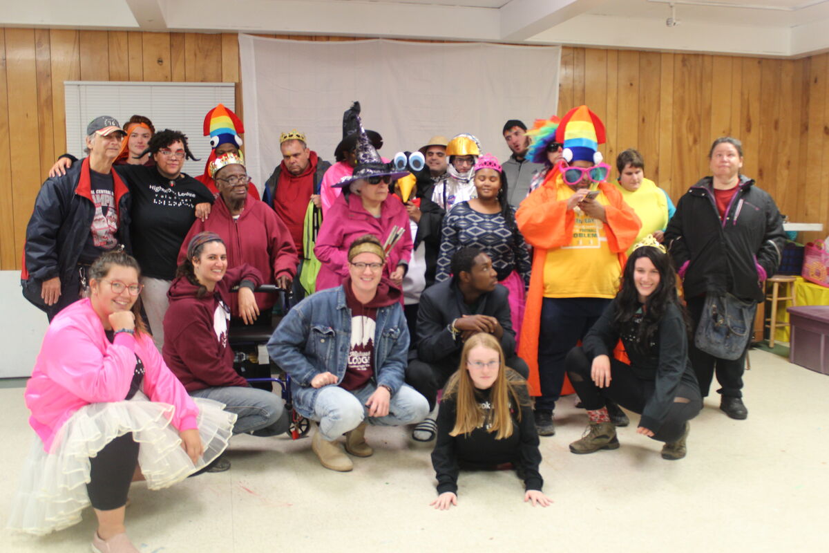 a bunch of campers dressed in costume smiling for the camera