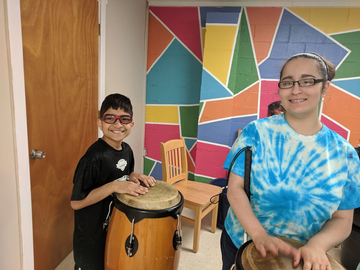 image of two clients playing drums