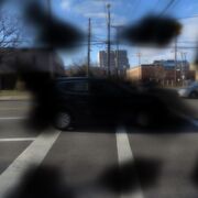 An example of what the view of a car would look like if you had diabetic retinopathy. There are patches of black obstructing the view of the car.