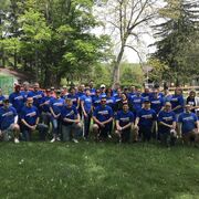 Large group of volunteers posing outside.