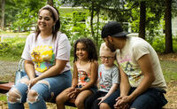 Emmett sits with his family on a bench outside. From left to right: Mom Jessica, Emmett's sister, Emmett and Emmett's dad.