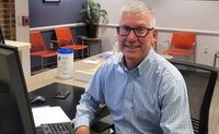 Dave smiles for the camera as he sits behind the front desk at CSC