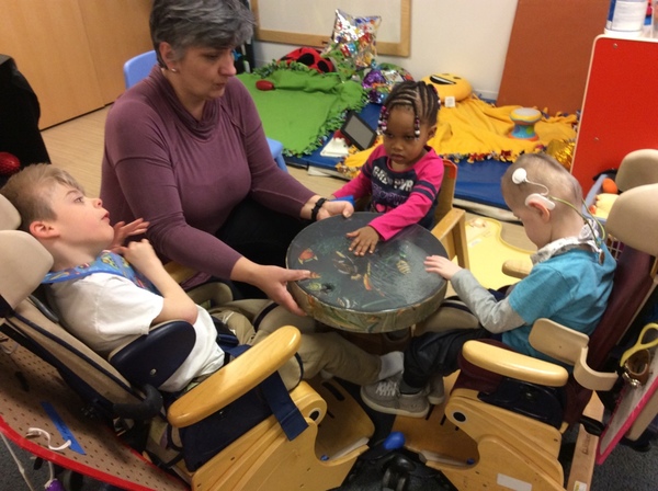 image of 3 students and preschool teacher